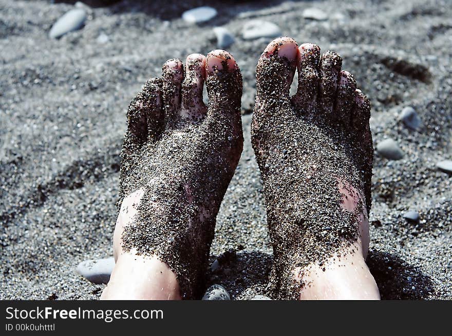 Feet In Pebbles On The Beach