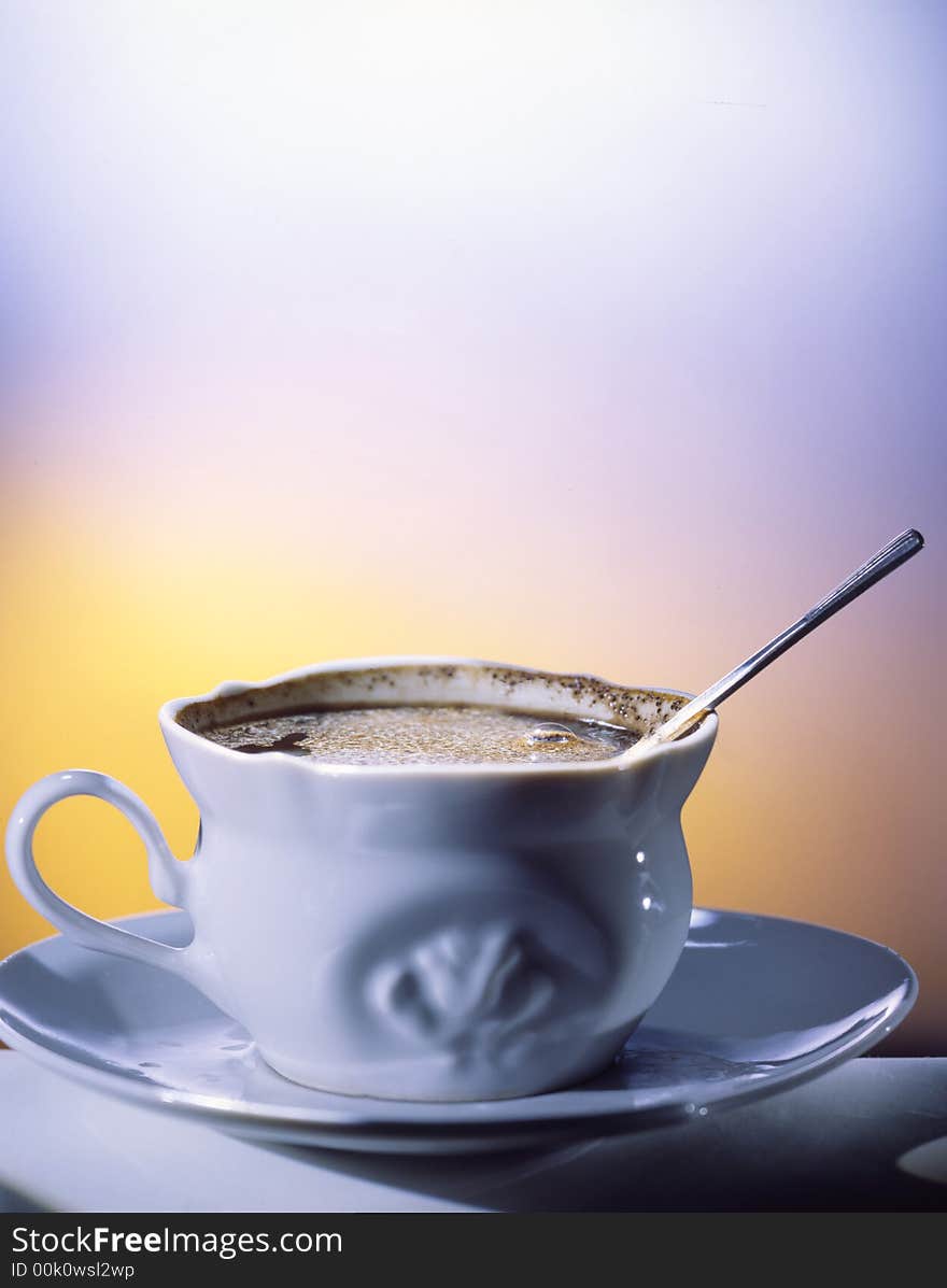 Cup of coffee on a table with the spoon