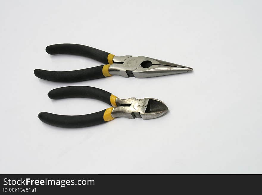 A set of longnose and diagonal pliers isolated on white background. A set of longnose and diagonal pliers isolated on white background