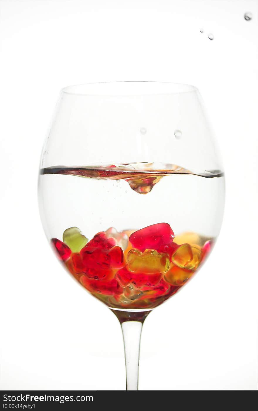 Water splash in a glass full of jelly bears. Water splash in a glass full of jelly bears