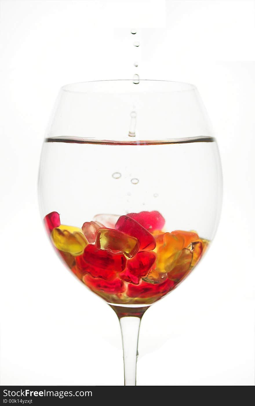 Water splash in a glass full of jelly bears. Water splash in a glass full of jelly bears