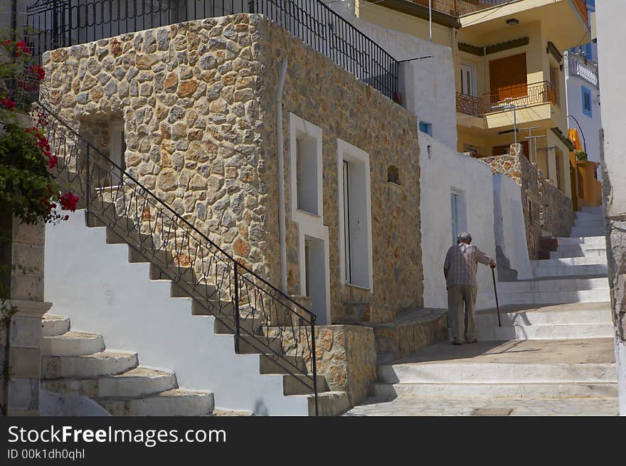 An old man is slowly walking up the stairs. An old man is slowly walking up the stairs