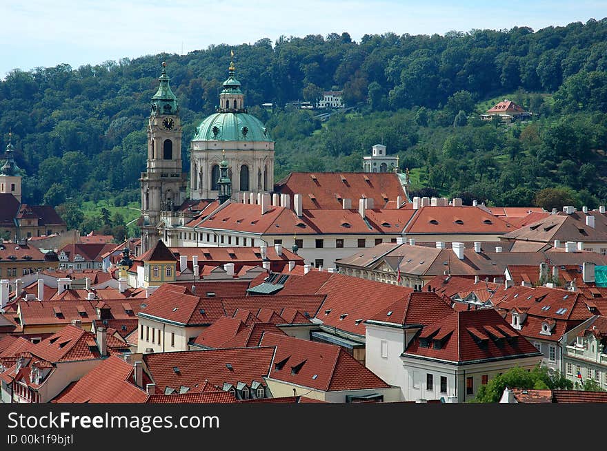 Prague red tile roofs and church