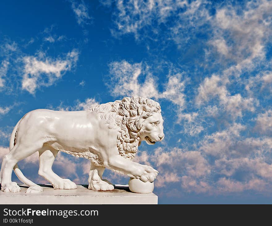 Sculpture of a white lion on a background of the blue sky