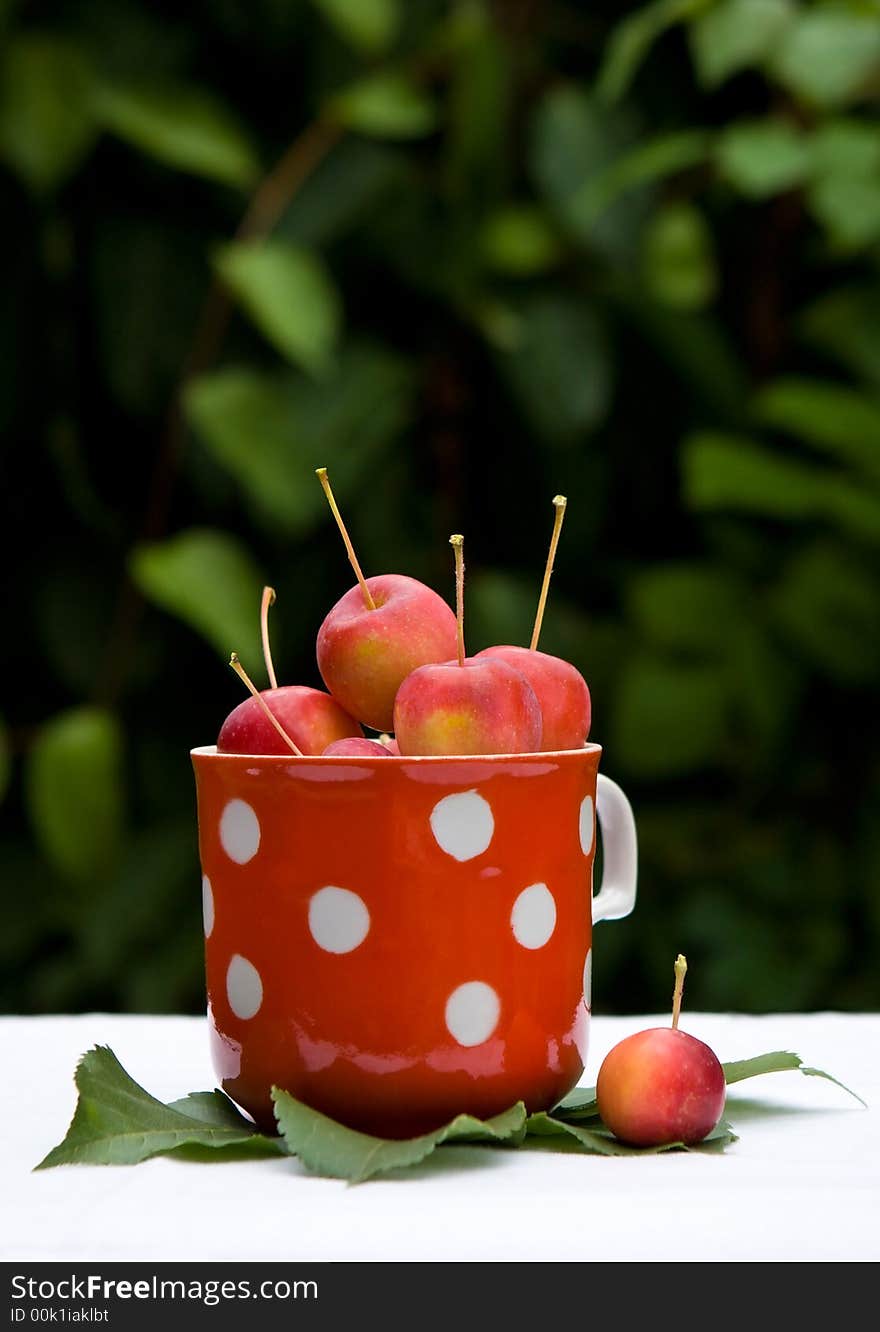 Small red apples in the cup