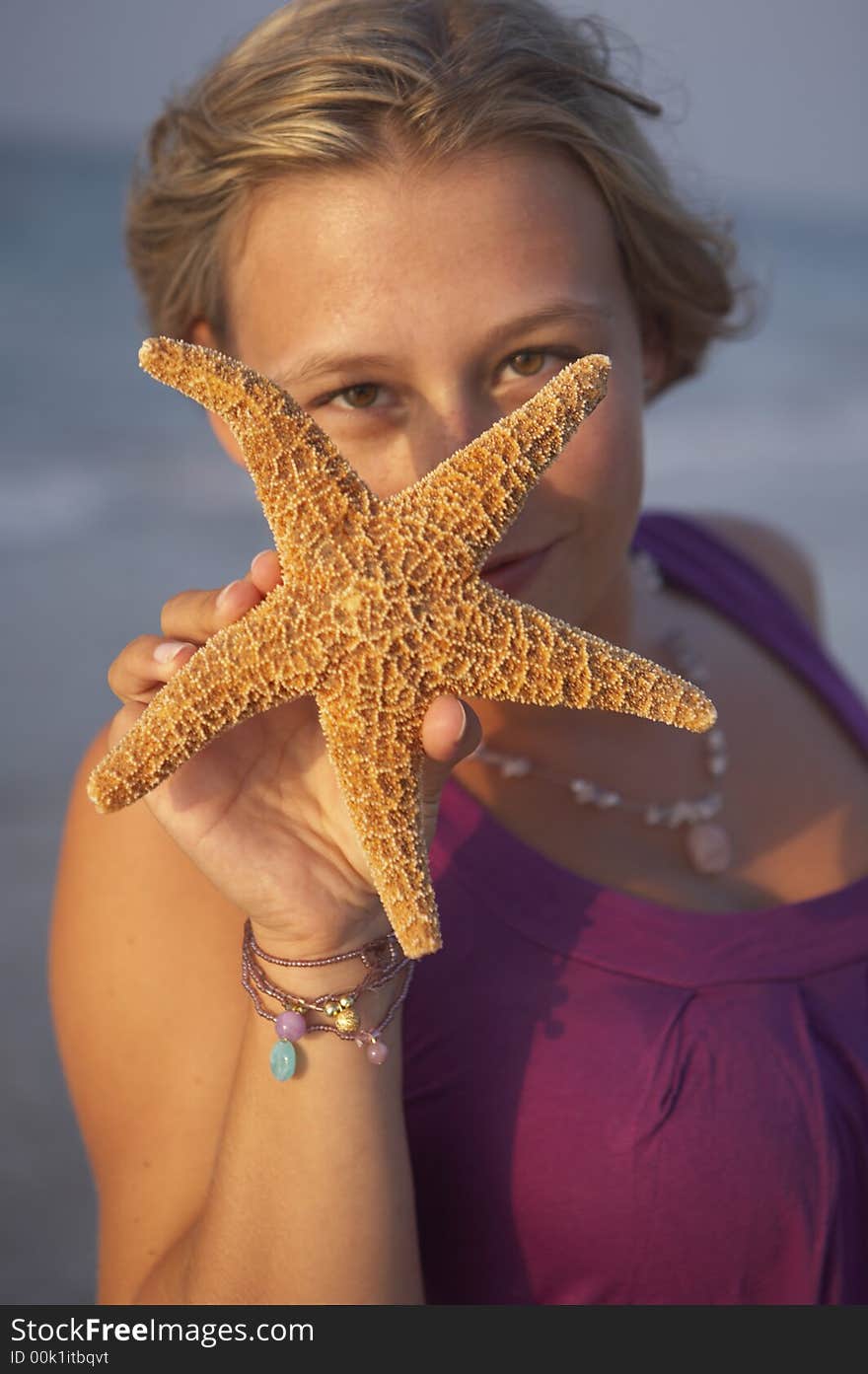 Cute girl is holding seastar