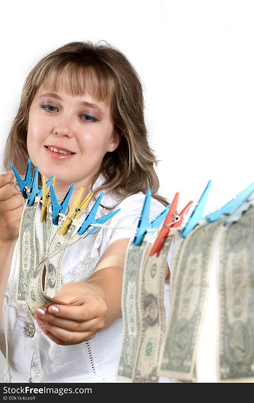 An image of smilling woman hanging up dollars. An image of smilling woman hanging up dollars