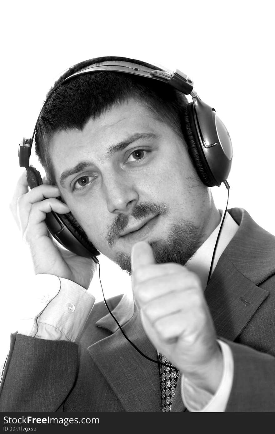 A businessman listening to music. A businessman listening to music