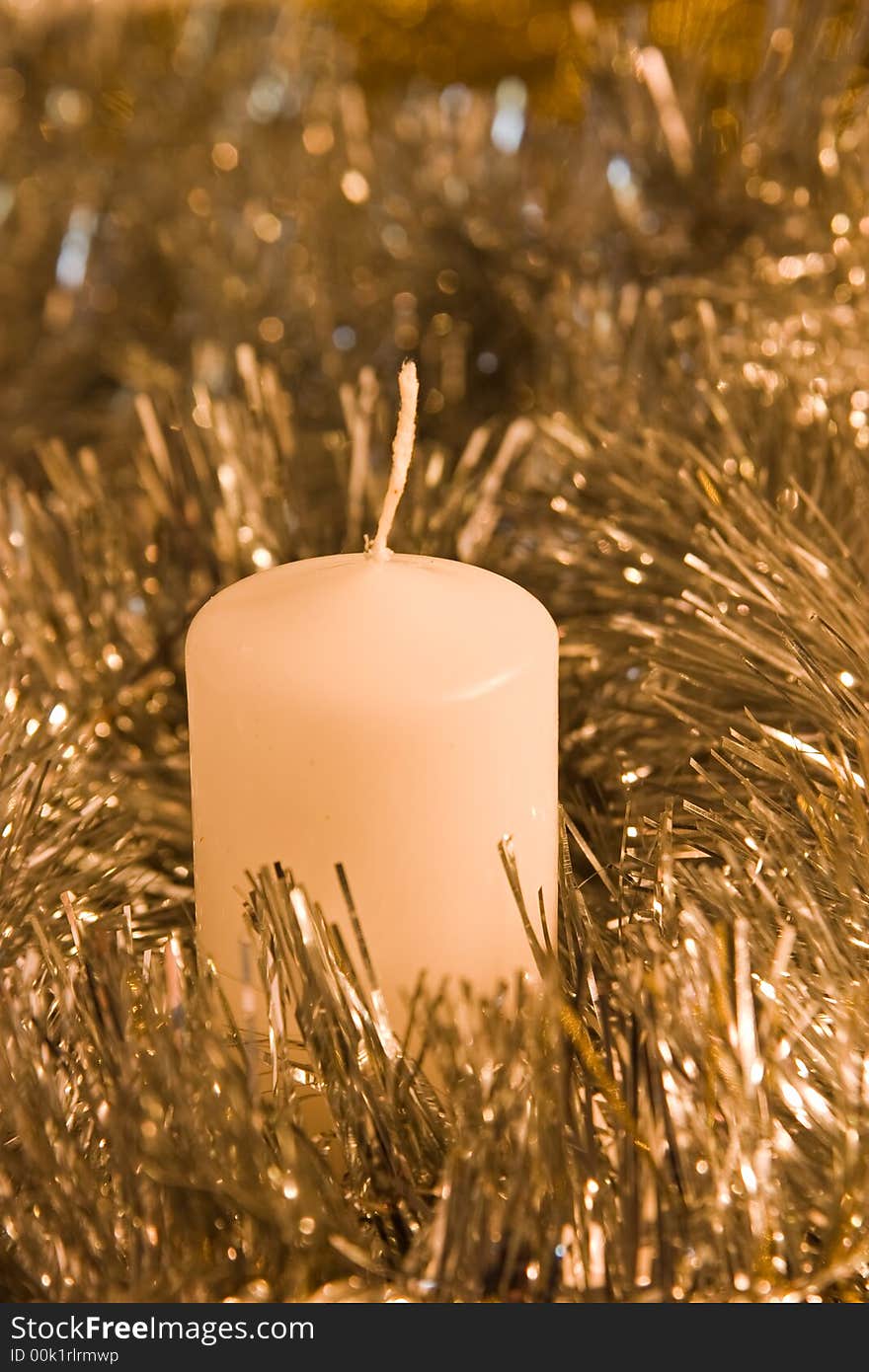 Candle in silver and golden tinsel