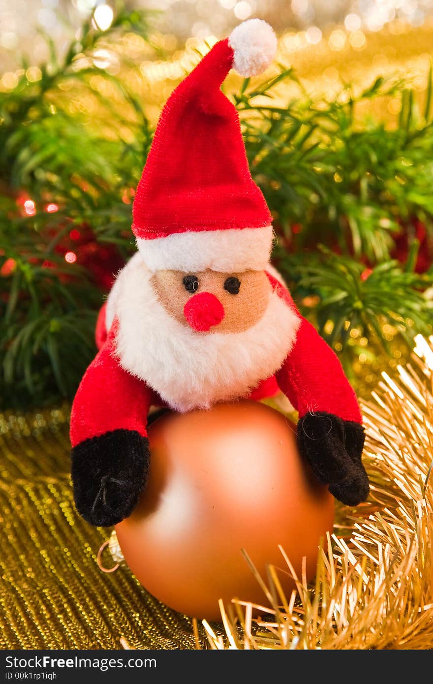 Santa toy with a golden bauble. Santa toy with a golden bauble