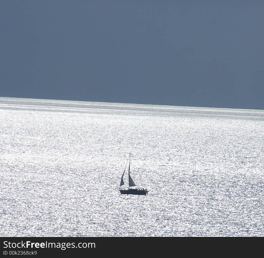 Sailing boat on sunny sea