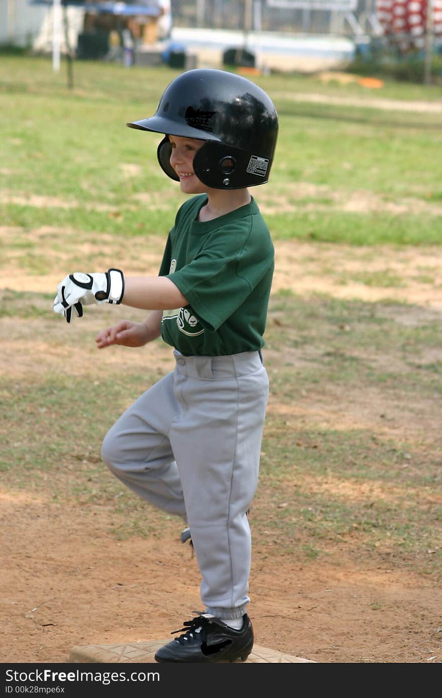 Happy T-ball player on first base. Happy T-ball player on first base.