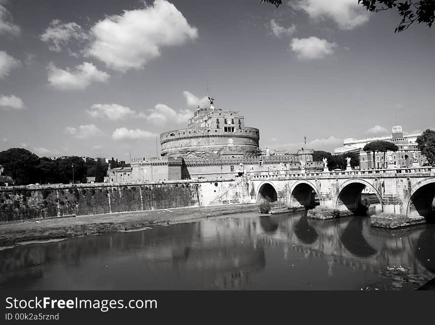 Domed building with a bridge over the river Tiber. Location is Castel Sant'Angelo, Vatican city, Rome. Also known as The Mausoleum of Hadrian.