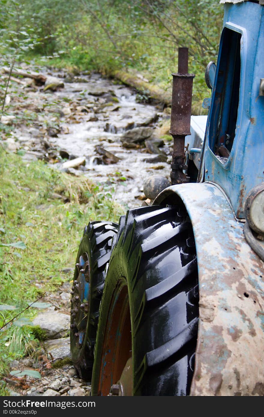 Tractor on the siberian mountain road