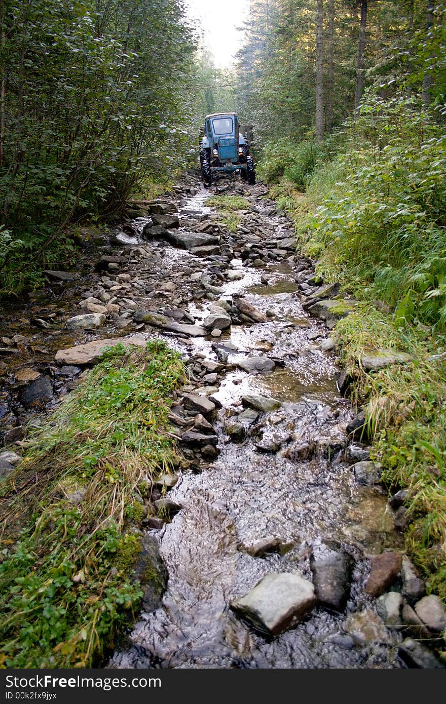 Tractor on the siberian mountain road