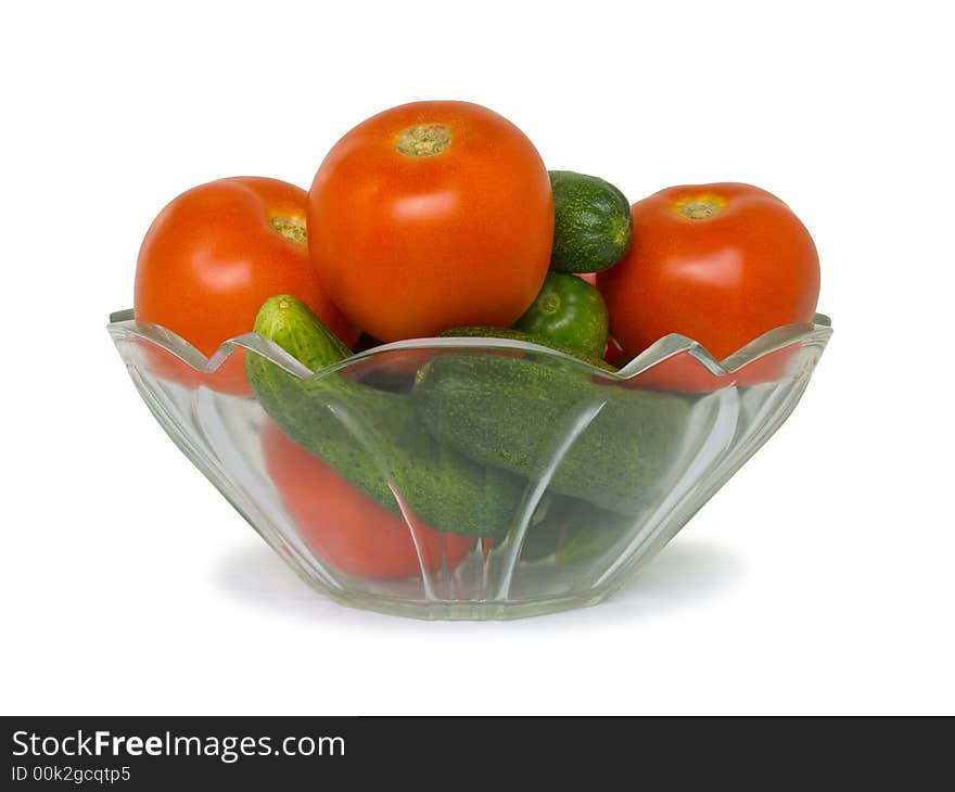 Cucumbers and tomato in bowl, isolated on white background