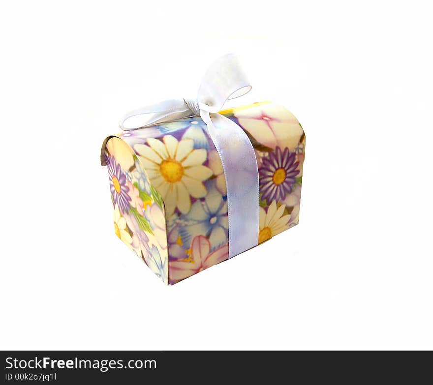 Flower-decorated small gift box with whitish ribbon, over white. Flower-decorated small gift box with whitish ribbon, over white