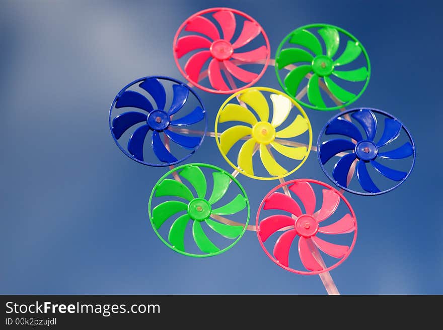 Colorful spinner toy on blue sky backgrouns