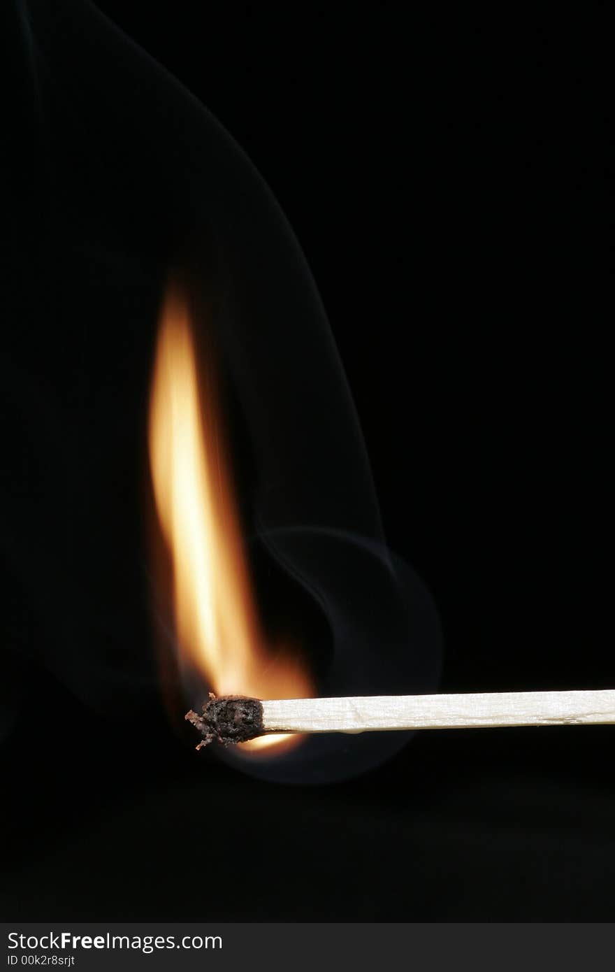 Burning Flame On A Single Matchstick On A Black Background. Burning Flame On A Single Matchstick On A Black Background