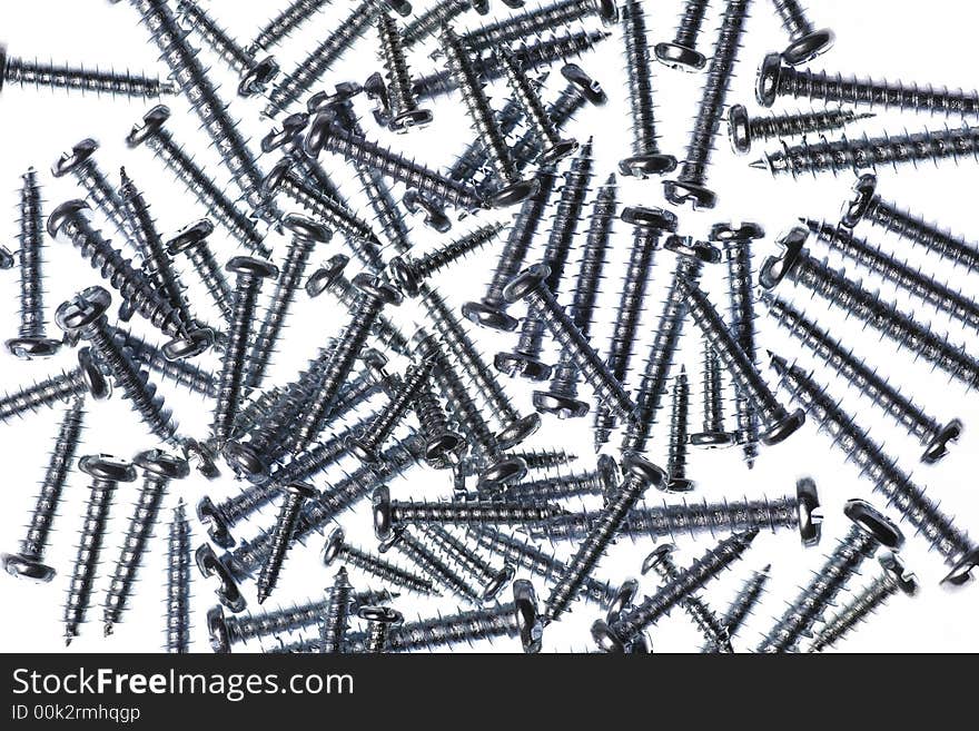 Many Spiral Metal Screws On A White Background