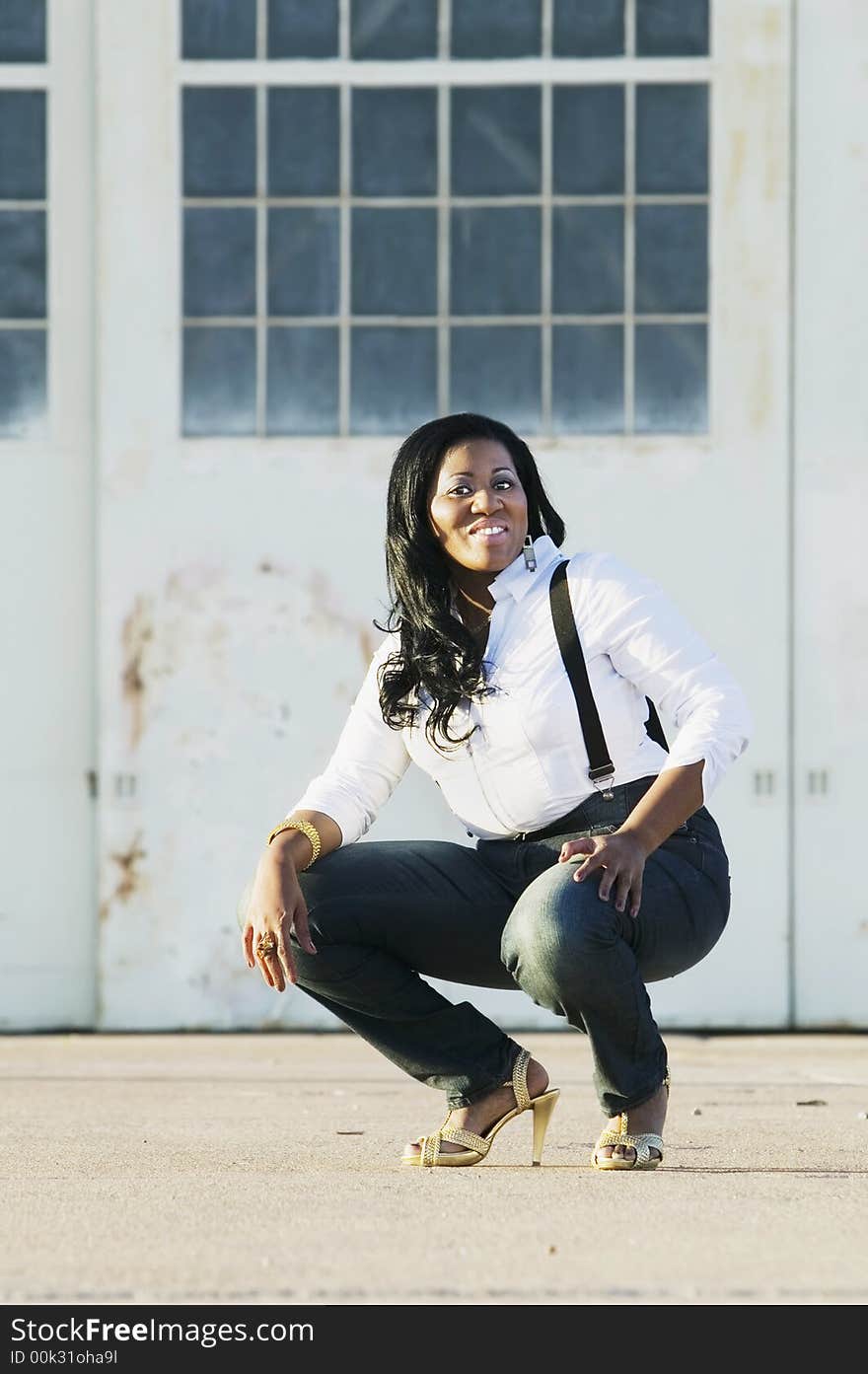 Medium shot of an African American woman at an industrial building.