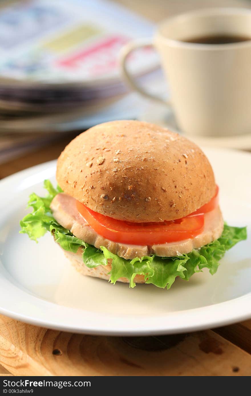 Break time - hamburger, tea and newspaper. Break time - hamburger, tea and newspaper