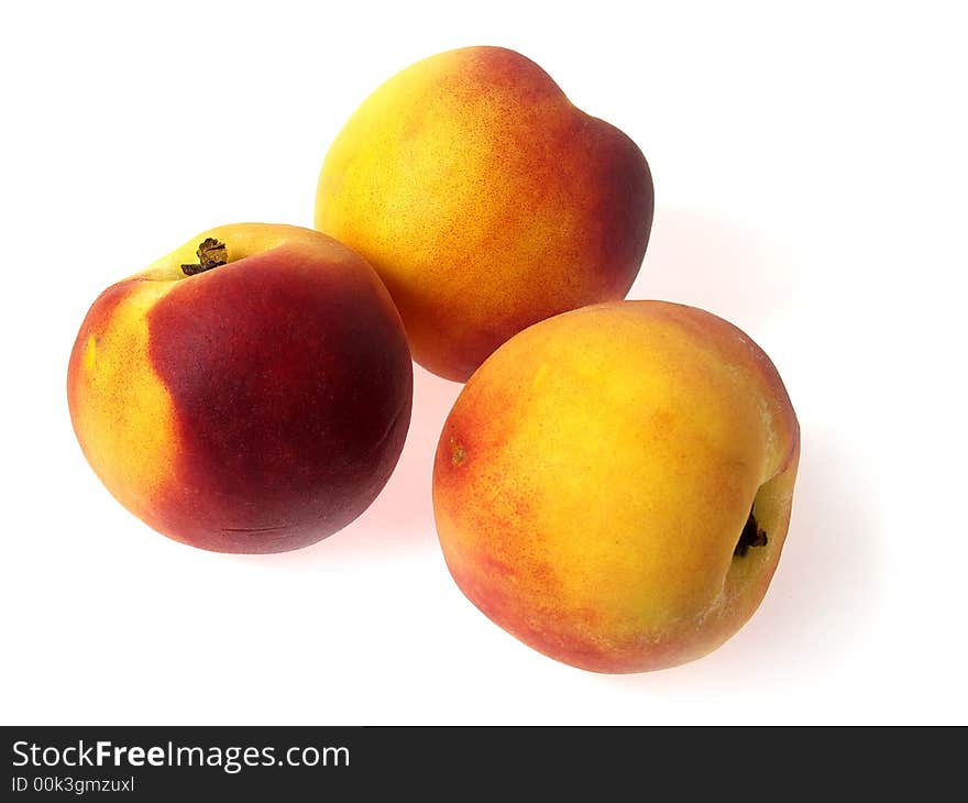 Tree tasty juicy peaches on a white background