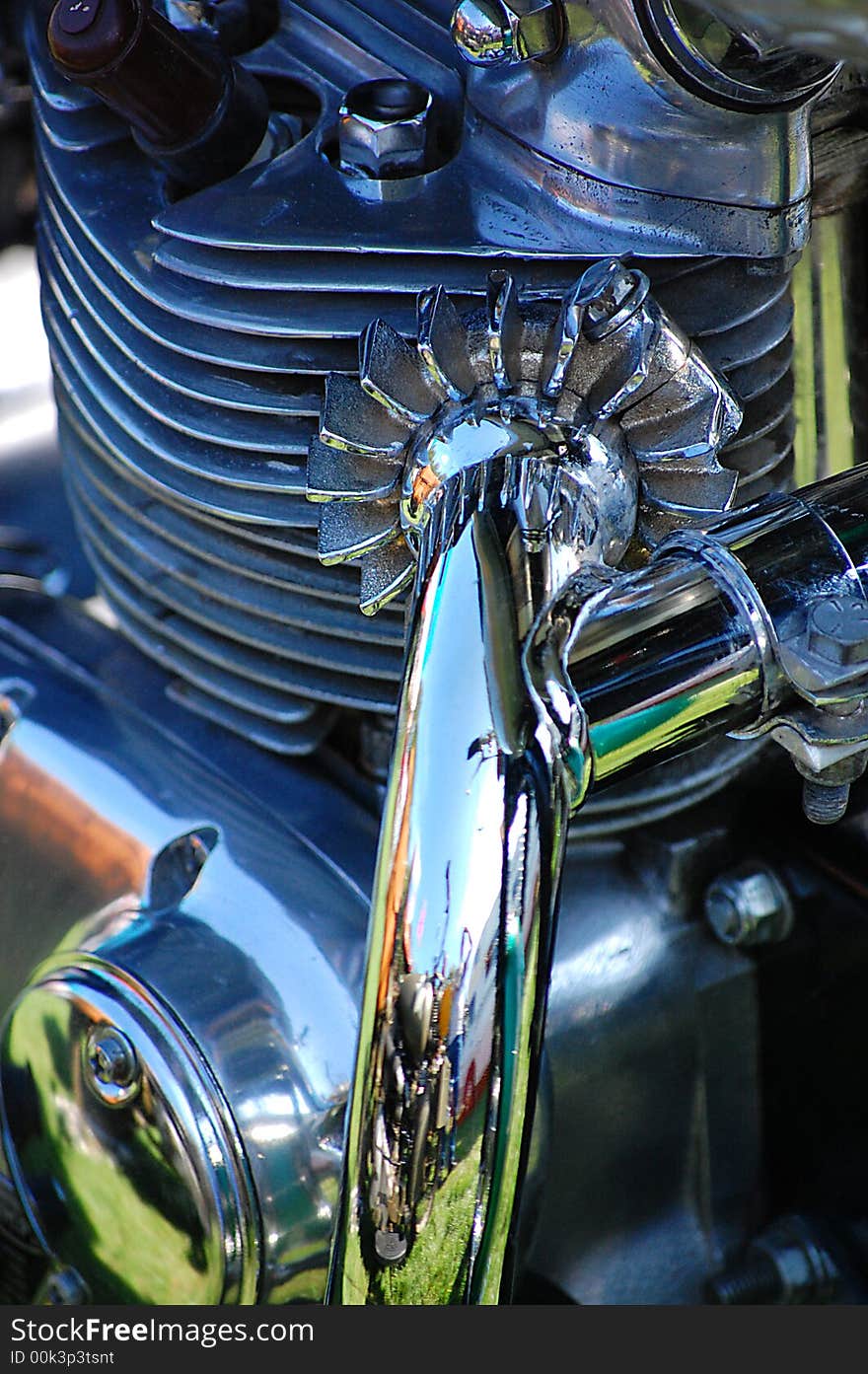 Close up Triumph engine 750 highly polished aluminum work high quality chrome on exhaust