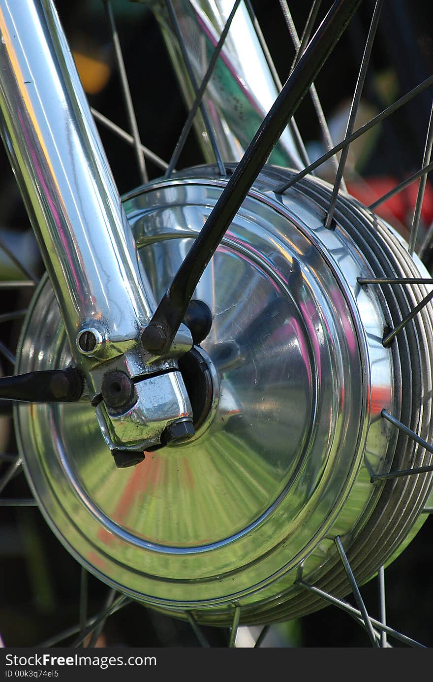 Close up of vintage motor cycle front hub and forks highly polished aluminum work. Close up of vintage motor cycle front hub and forks highly polished aluminum work