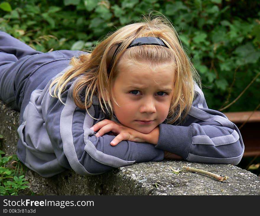 The child lying in the park and watching to you. The child lying in the park and watching to you.