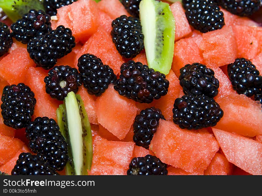 Detail of fruit salad with watermelon, kiwi and blackberry