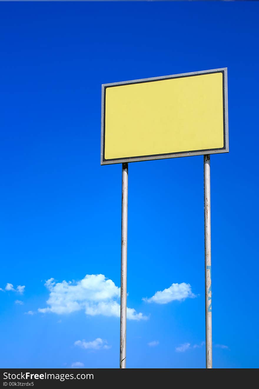 Blank yellow sign against deep blue sky. Blank yellow sign against deep blue sky