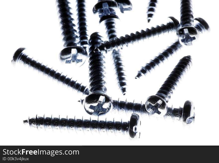 Macro Close-Up Of Spiral Metal Screws On A White Background