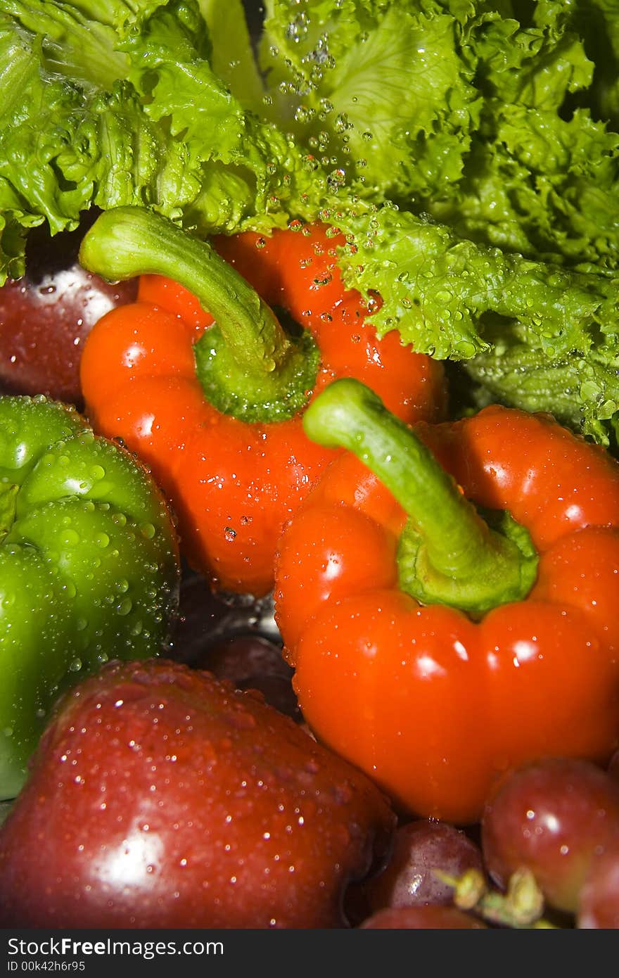 Close up of fruits and vegetables under the stream of water. Close up of fruits and vegetables under the stream of water