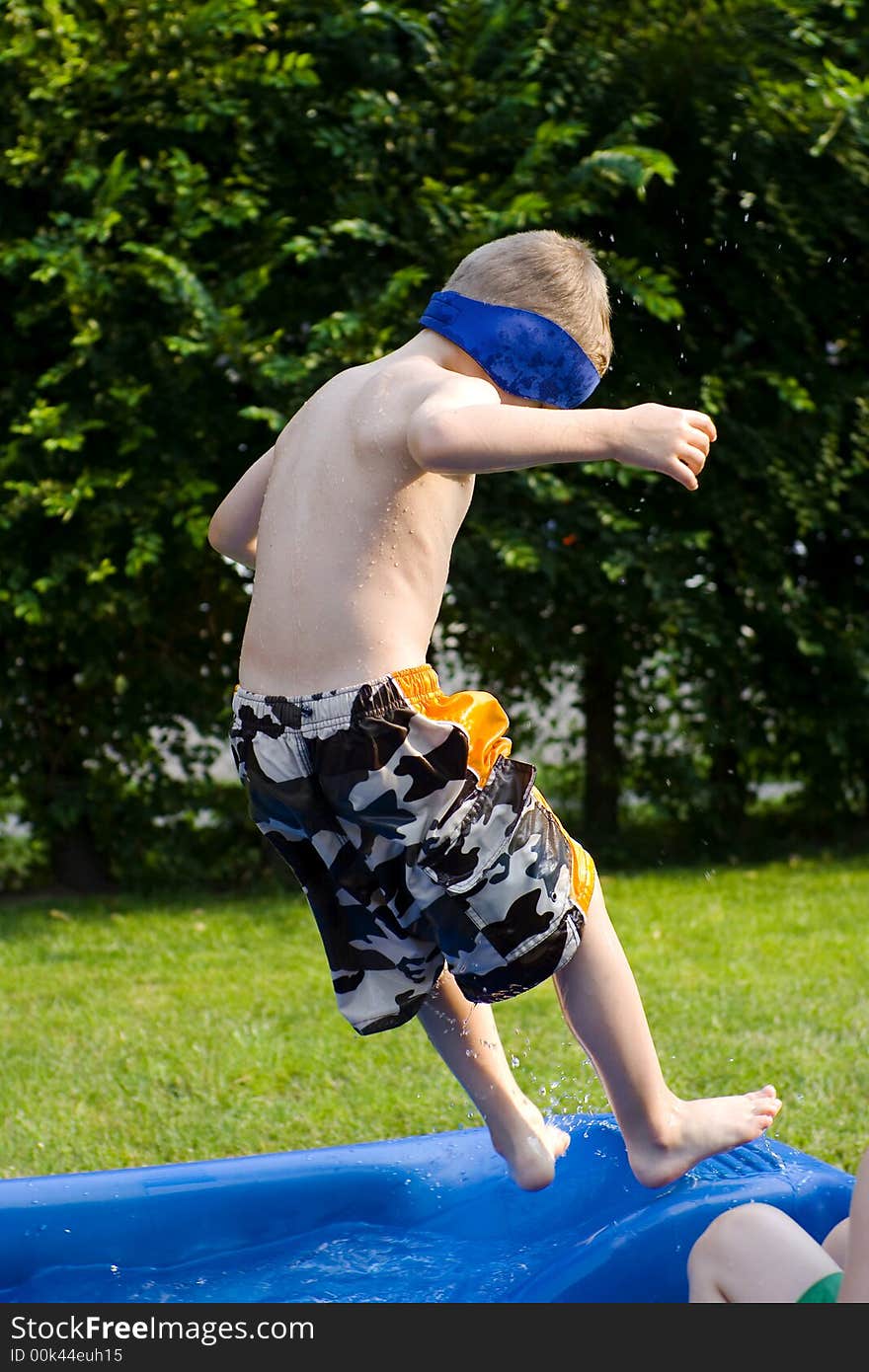 Child jumping to a swimming pool. Child jumping to a swimming pool