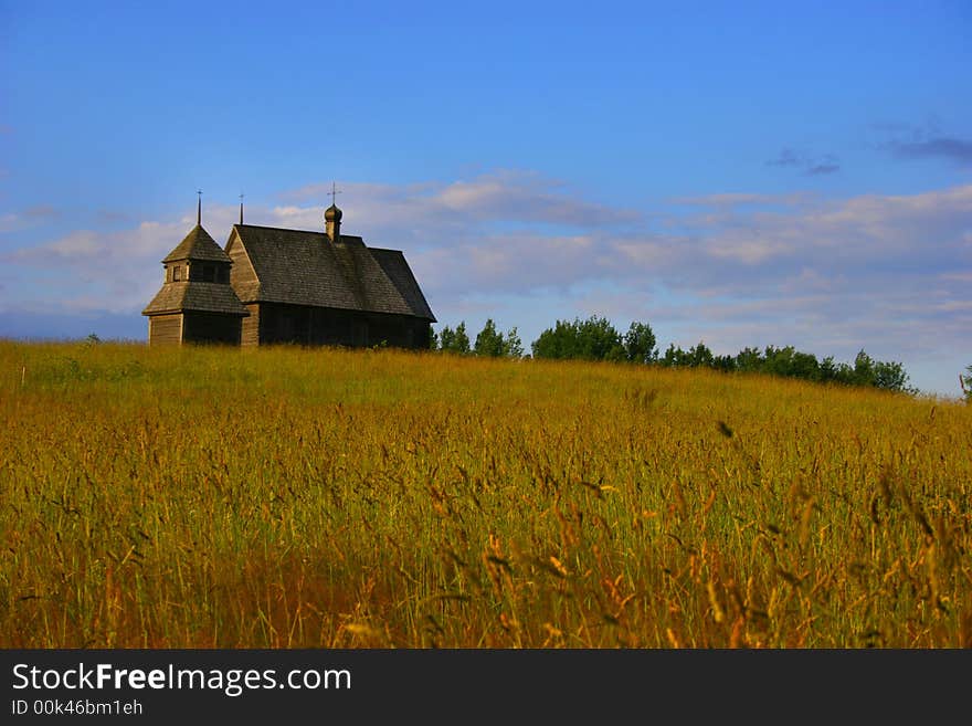 The old thrown house on a gold hill on a background of the dark blue sky