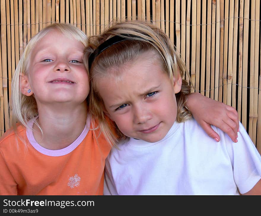 Brother and sister sitting and smilling. Brother and sister sitting and smilling.