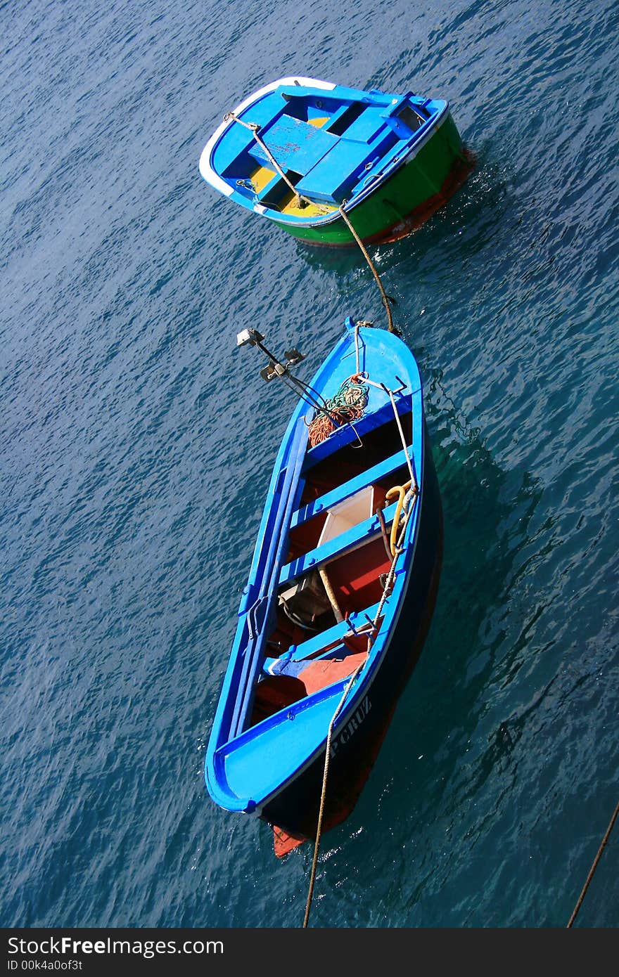 Fishing blue painted boats on a calm sea tropical water at the Canary Islands. Fishing blue painted boats on a calm sea tropical water at the Canary Islands