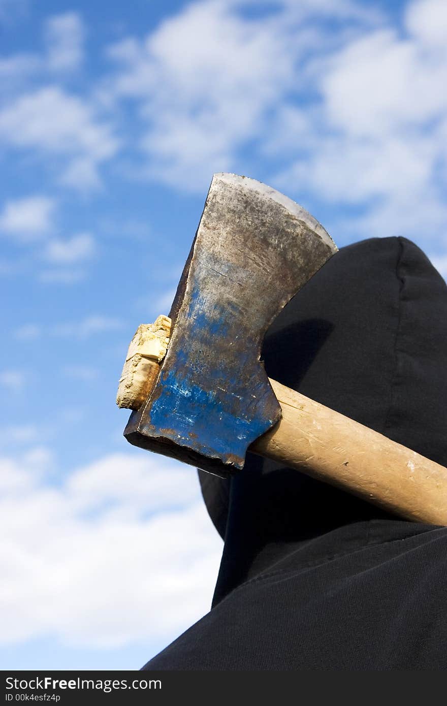 Man with an axe on sky background