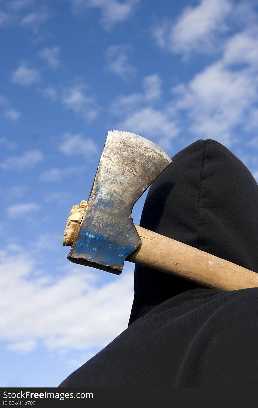 Man with an axe on sky background