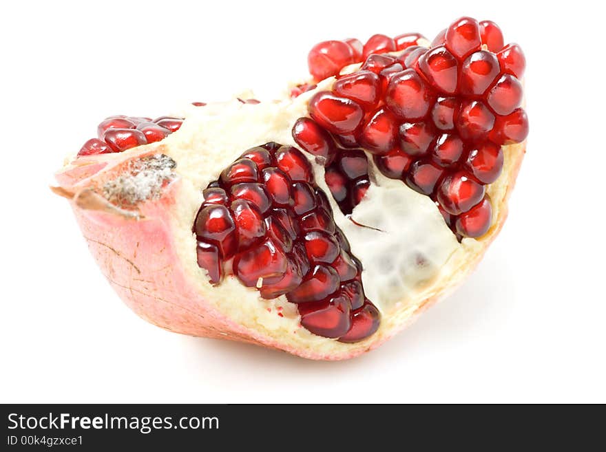 Piece of ripe pomegranate isolated on white background.