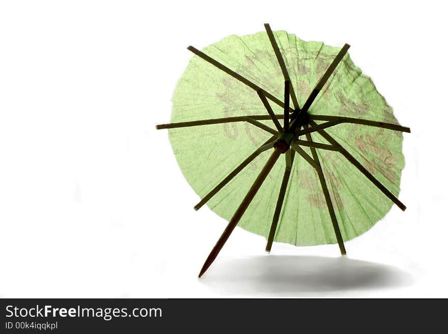 Backlit green paper umbrella over white background. Backlit green paper umbrella over white background