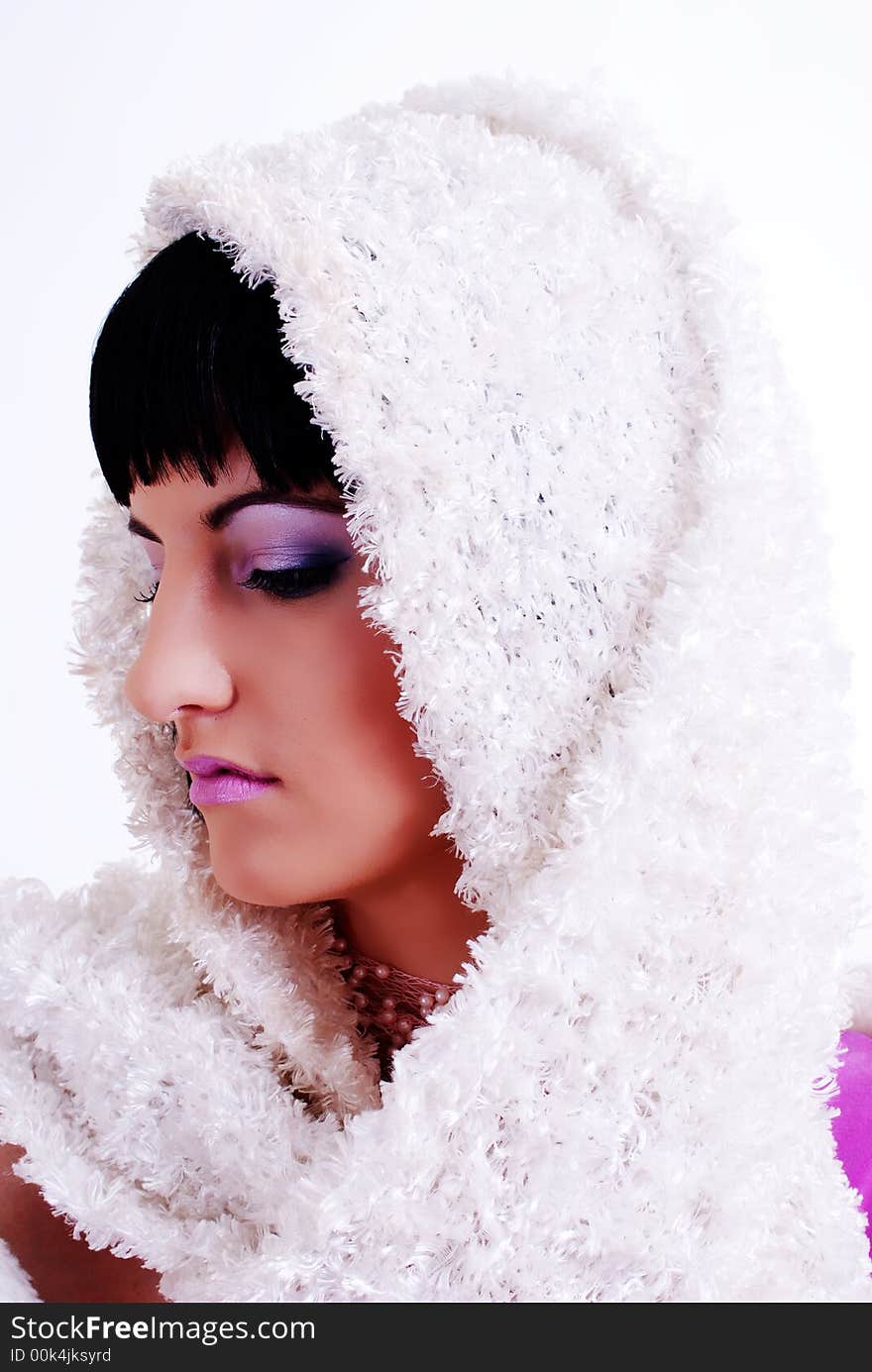 Portrait of a woman with white fur draped over her black hair with dramatic make up