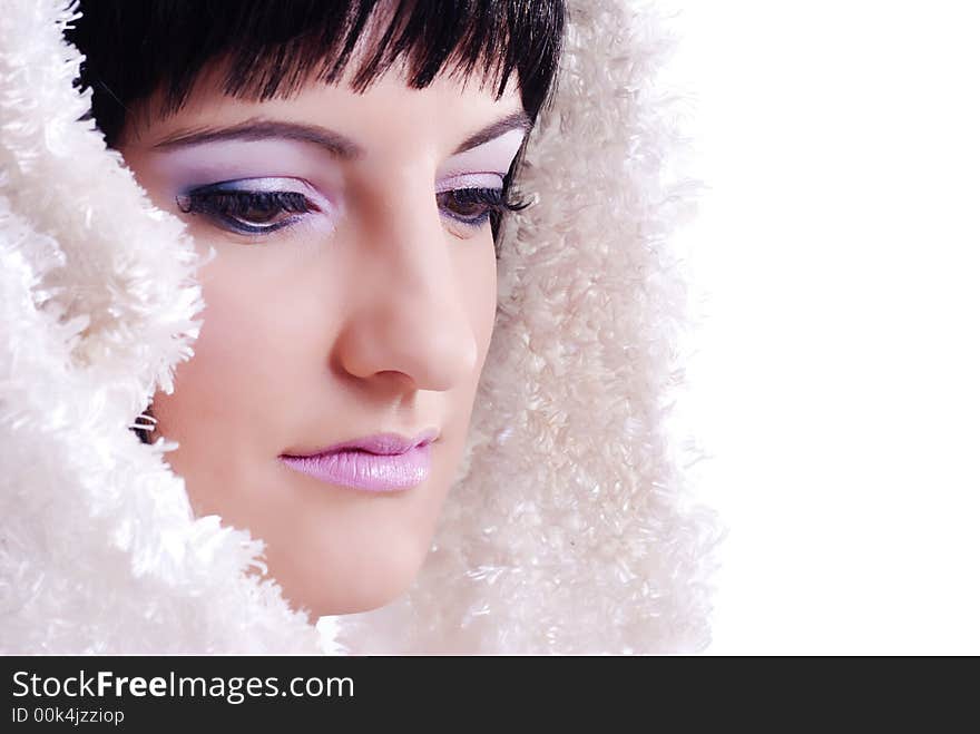 Close up of a woman with white fur draped over her black hair. Close up of a woman with white fur draped over her black hair