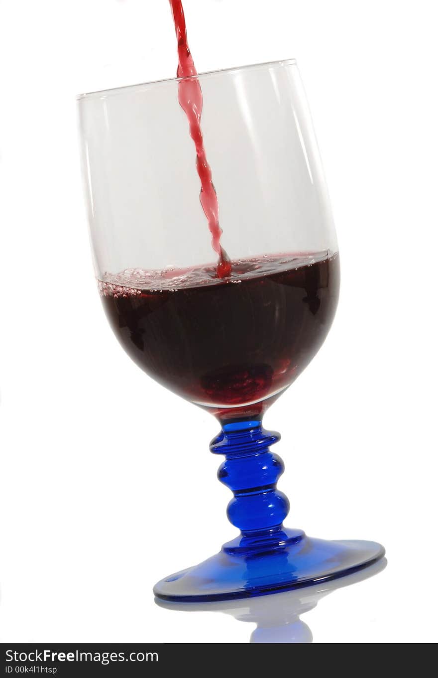 Red wine pouring down into a wine glass