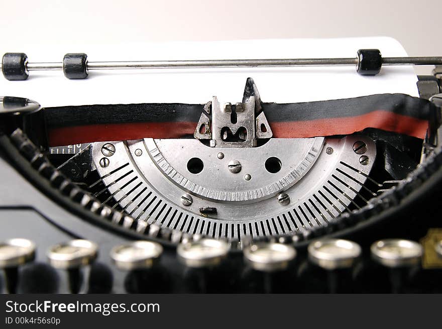 A close up photo of very old typewriter