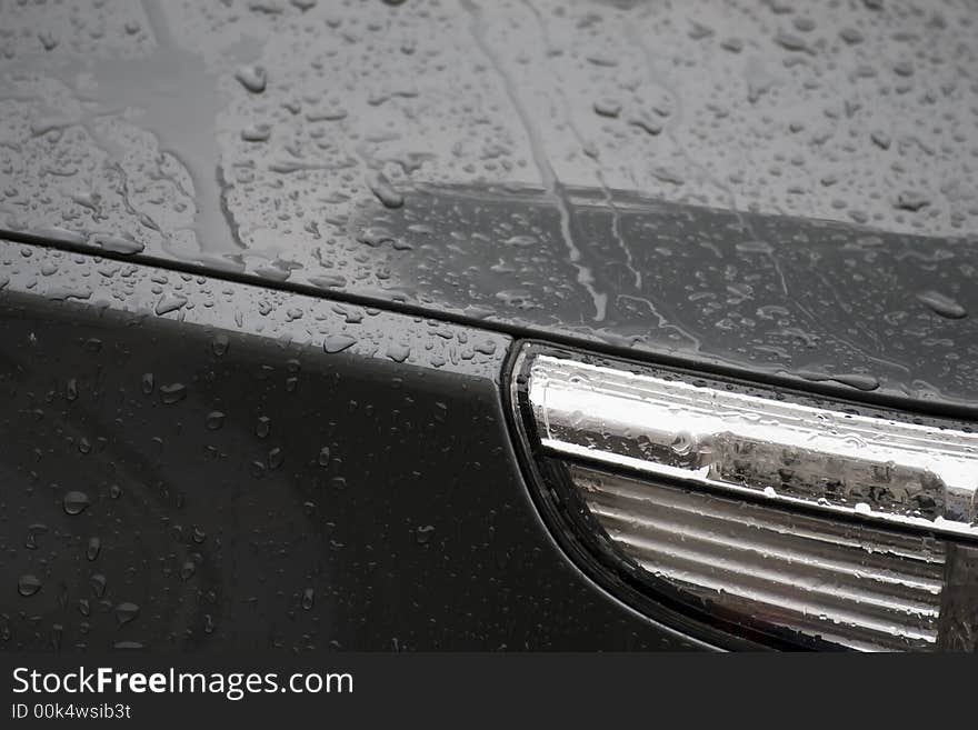 Water drops on black car surface. Water drops on black car surface.