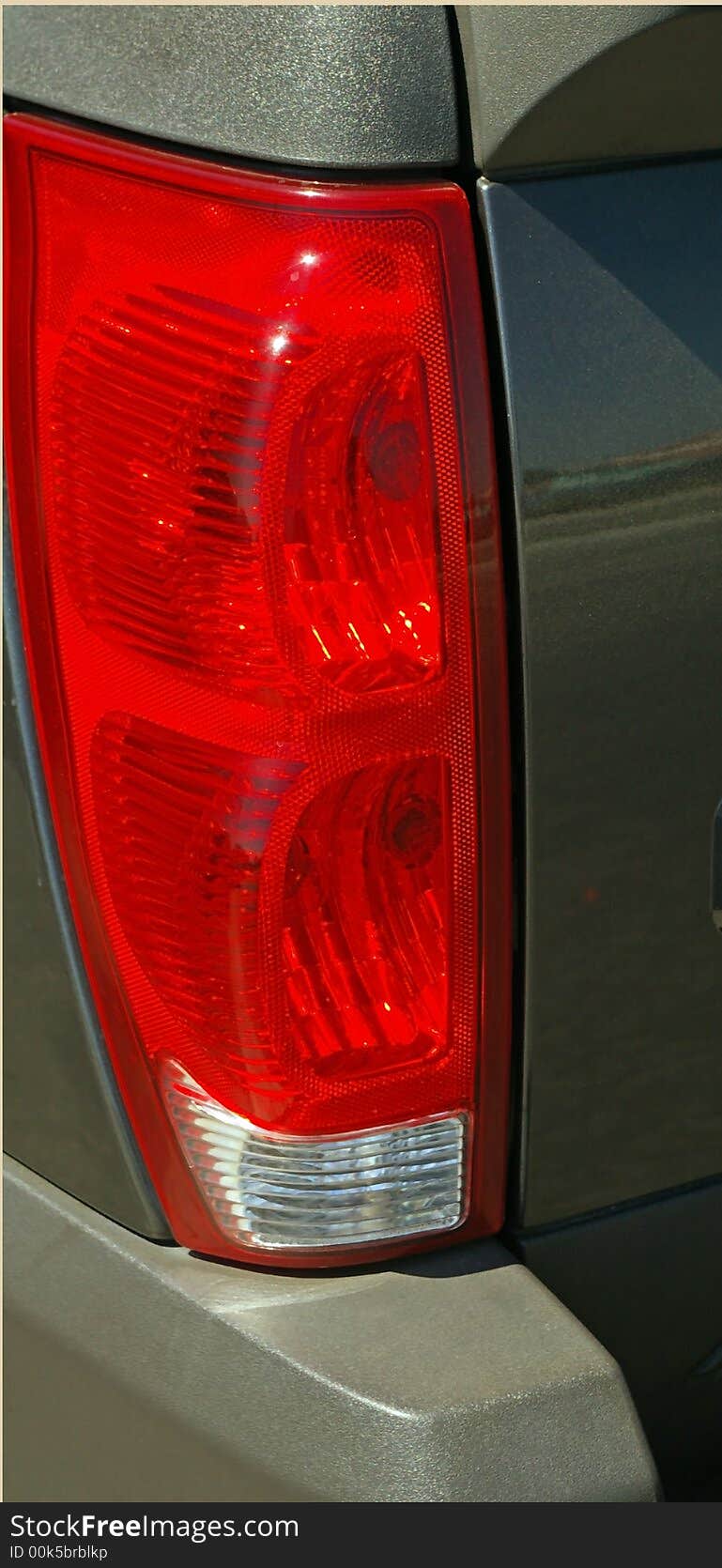 Tail light of a parked vehicle.