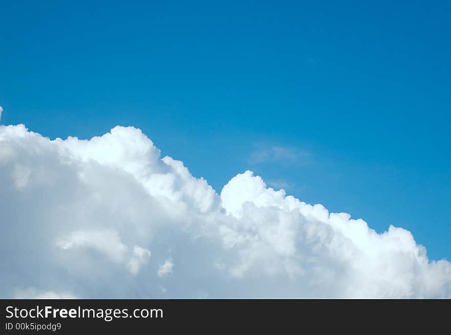 An image of blue sky with white clouds. An image of blue sky with white clouds