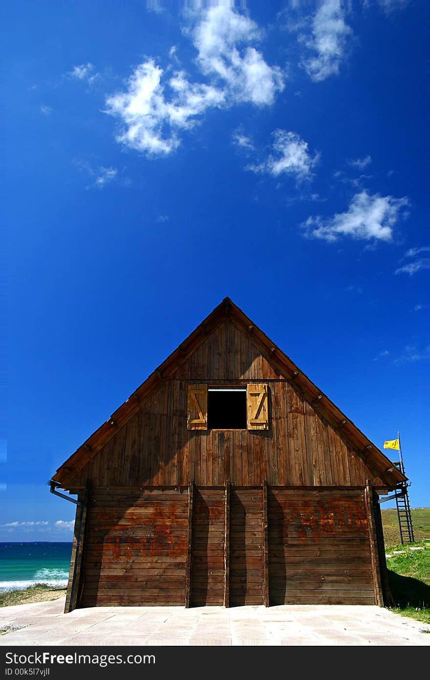 A photo of a wood cabin by the beach. A photo of a wood cabin by the beach.